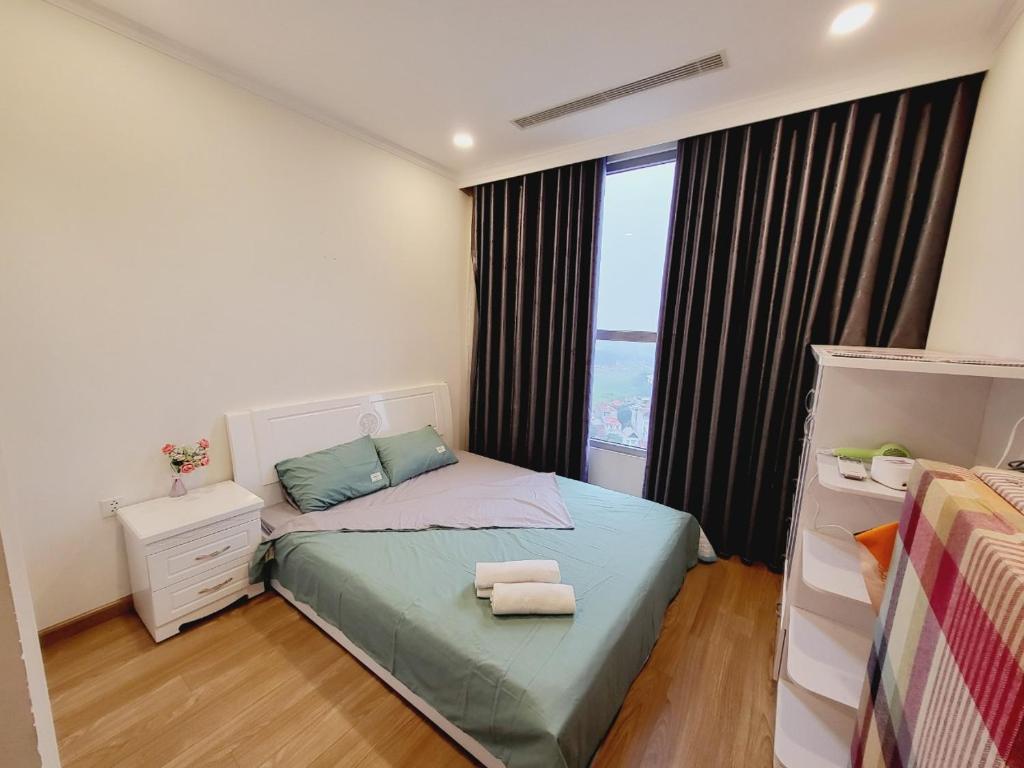 a small bedroom with a bed and a window at Mami House - Tecco Elite City Thai Nguyen Serviced Apartments in Thái Nguyên