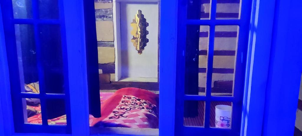a view of a room through a blue door at Devropa Heights in Malāna