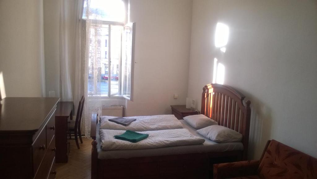 a bedroom with two beds and a window at Hostel Moravia Ostrava in Ostrava