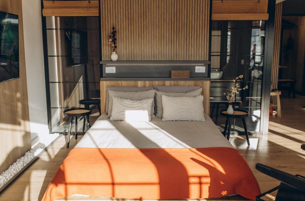 a bedroom with a bed with an orange and white comforter at Great Exodus - Iasi City Center in Iaşi