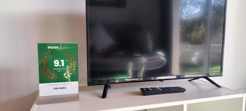 a tv sitting on a table with a remote control at Villa Daita 1 in Granadilla de Abona