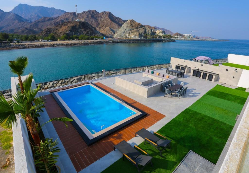 an aerial view of a house with a swimming pool at The Wave Villa - Fujairah in Fujairah
