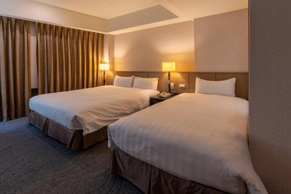 Postel nebo postele na pokoji v ubytování Guide Hotel Taipei Chongqing