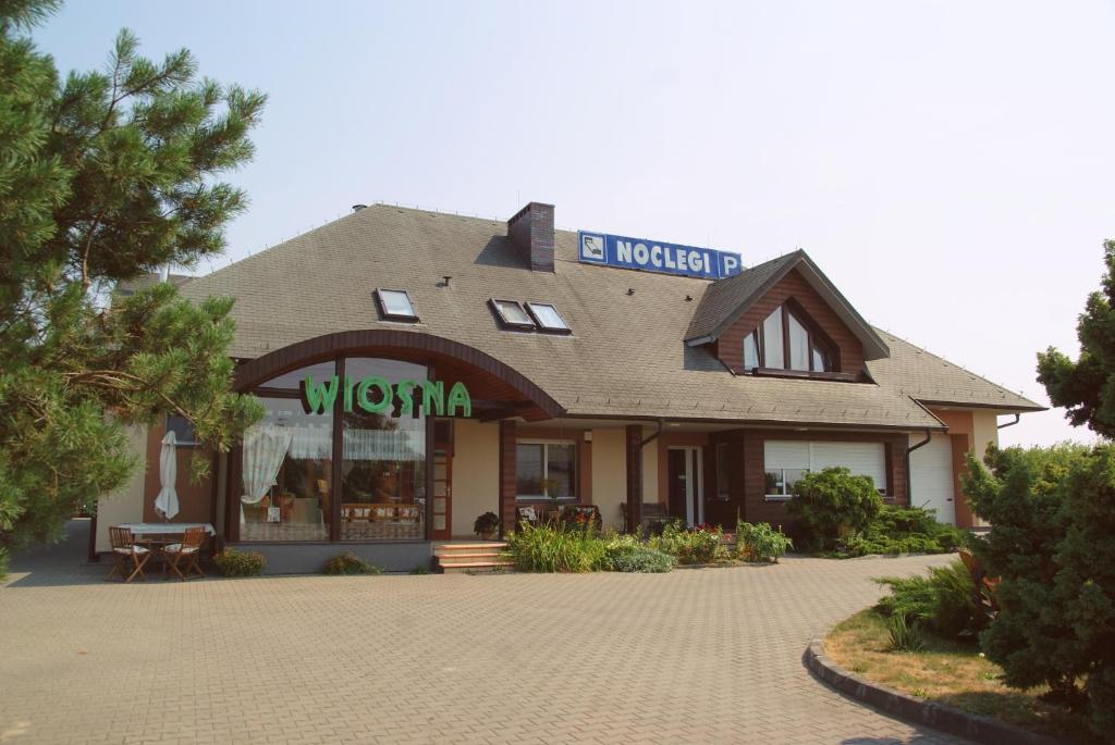 a building with a sign on the top of it at Willa Wiosna in Września