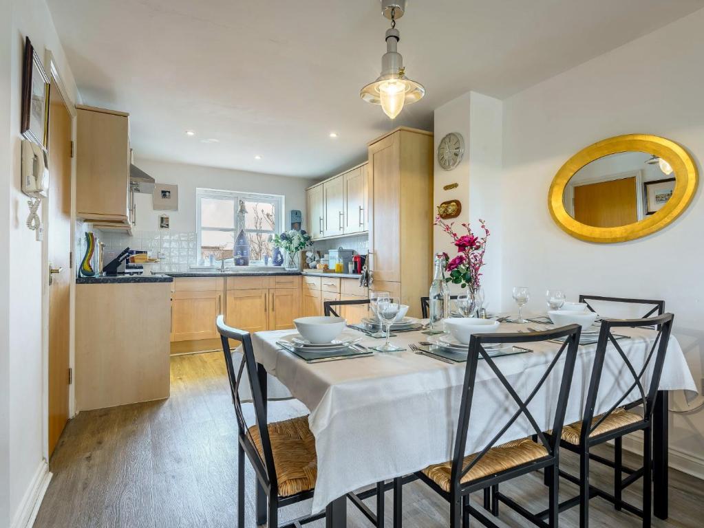 a kitchen and dining room with a table and chairs at 3 Bed in Brixham BX050 in Galmpton-on-the-Dart