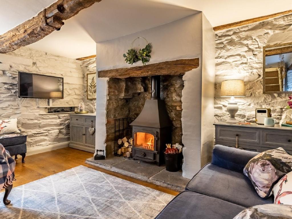 an open living room with a stone fireplace at 1 Bed in Bouth LCC40 in Bouth