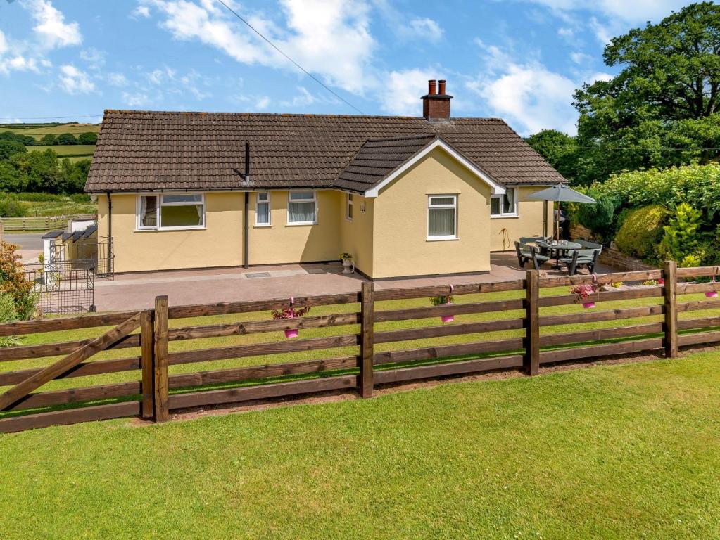 a house with a wooden fence in front of it at 3 Bed in Cantref BN363 in Brecon