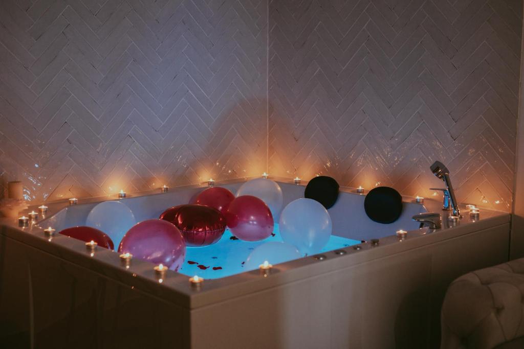 a bath tub filled with lots of colorful balloons at Luxury Jacuzzi Apartment in Mostar