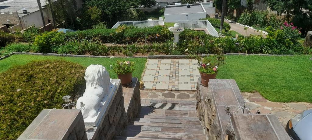a view of a garden with a statue and stairs at Goshen in Johannesburg
