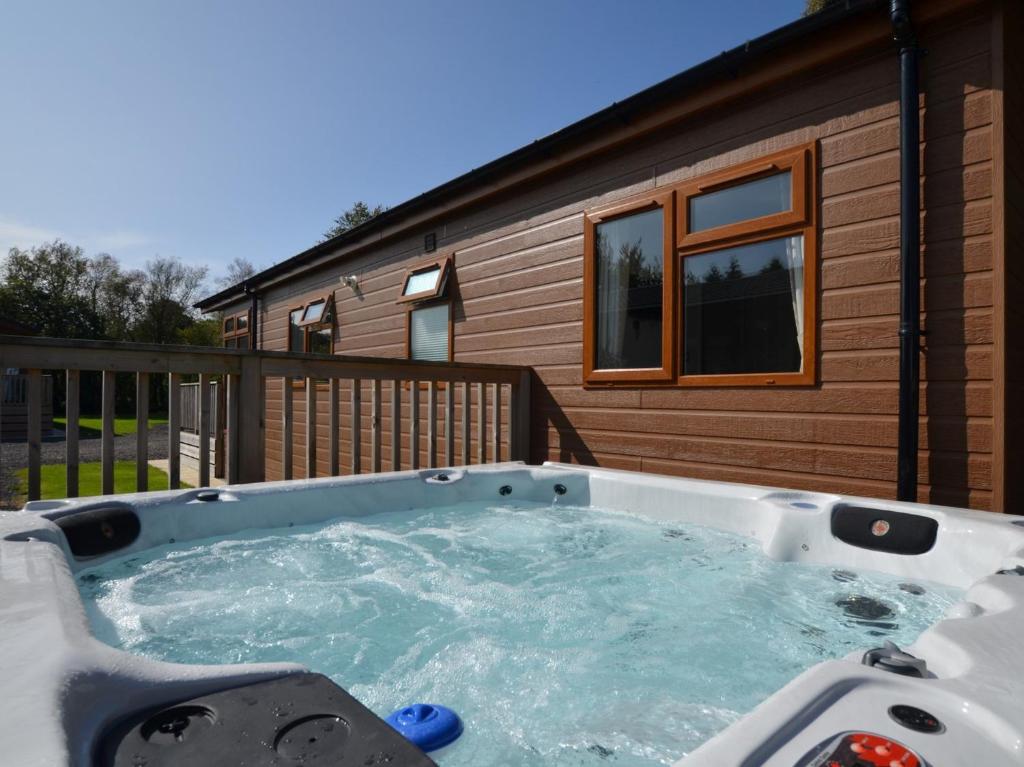 a hot tub in front of a house at 2 Bed in Okehampton 80373 in Okehampton