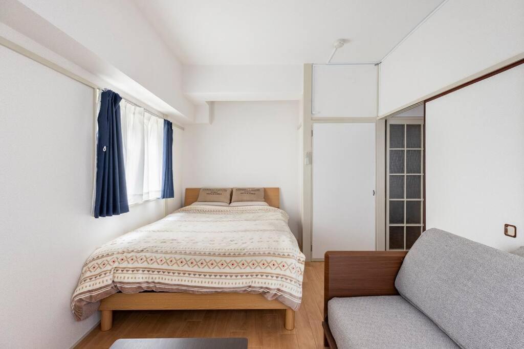 Ένα ή περισσότερα κρεβάτια σε δωμάτιο στο G&R House 202　Shinjuku room