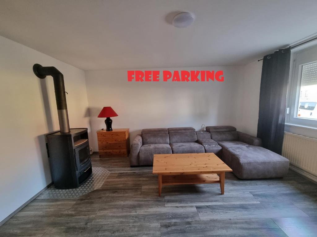 a living room with a free parking sign on the wall at ONE Self-Check-In, 3km freeway 