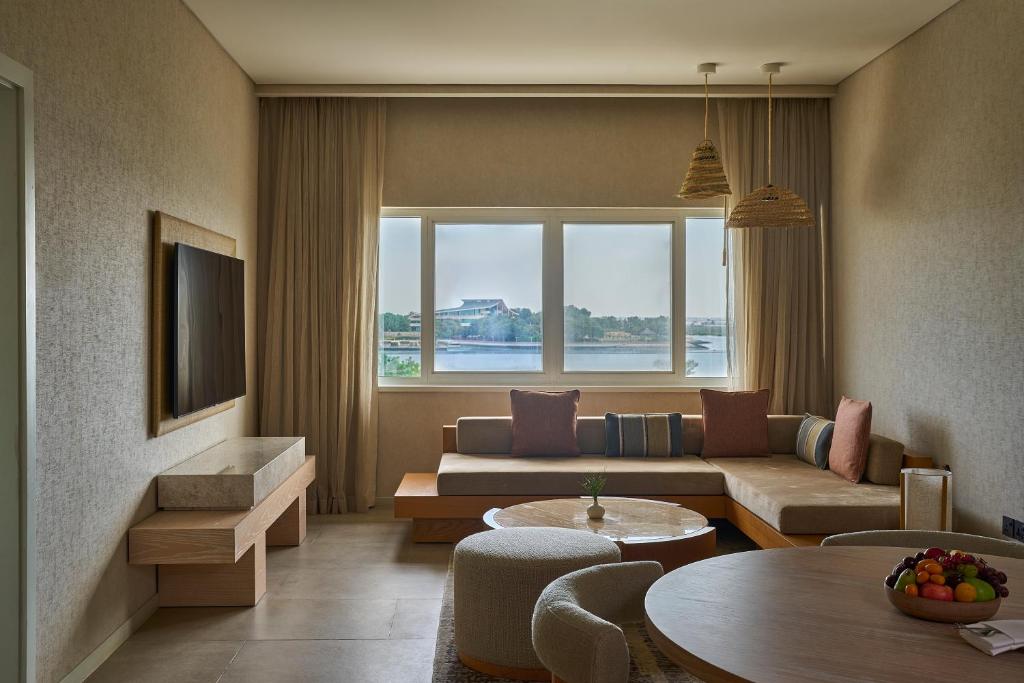 a living room with a couch and a table at ERTH Abu Dhabi Hotel in Abu Dhabi