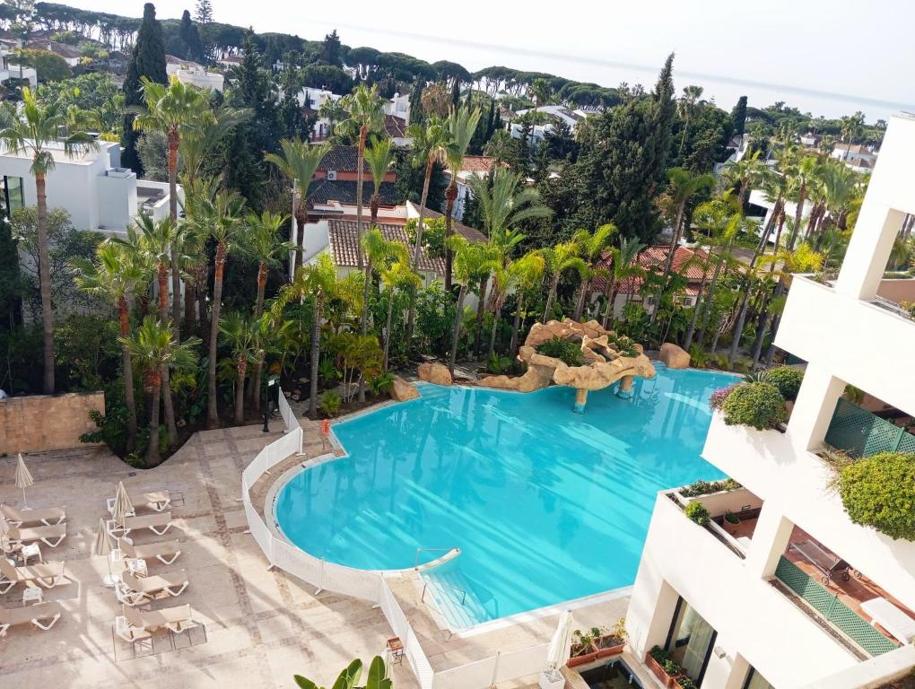 an aerial view of the pool at the hotel at Apartamento Atico Duplex HOTEL Guadalpin Marbella in Marbella
