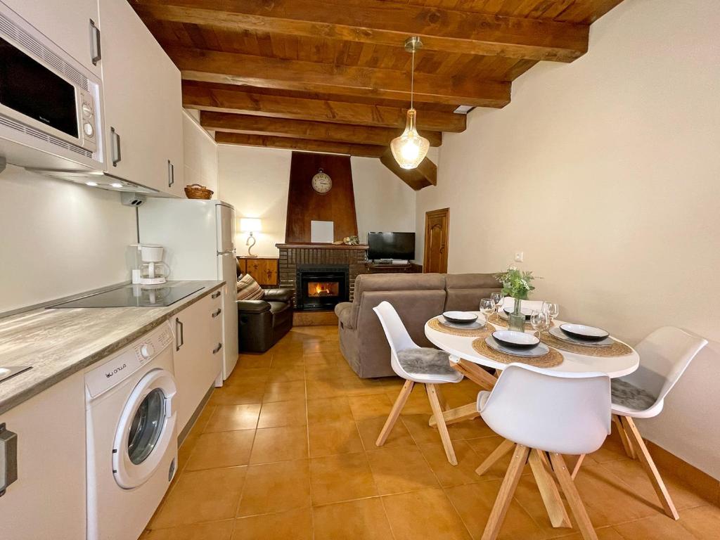 a kitchen and living room with a table and chairs at Etxetxikia in Ochagavía