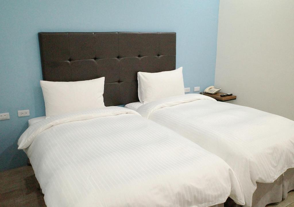 Postel nebo postele na pokoji v ubytování Happy Guesthouse