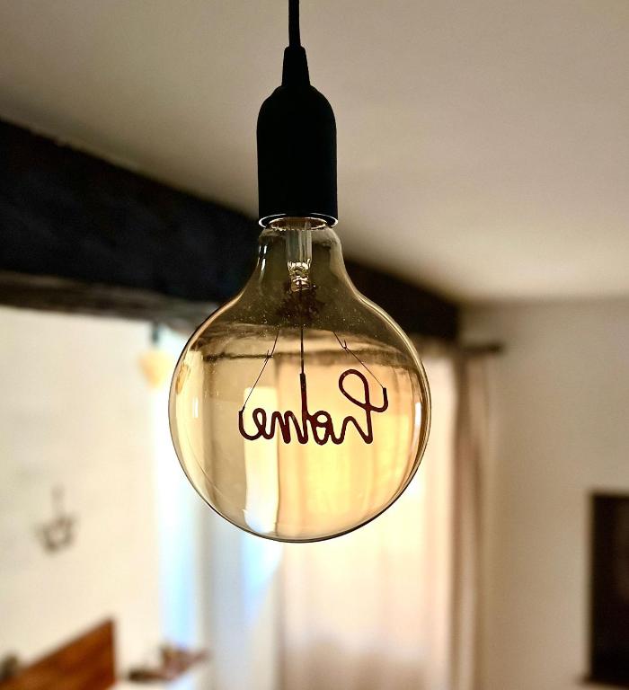 a glass light bulb hanging from a ceiling at La Sibillina in Sarnano