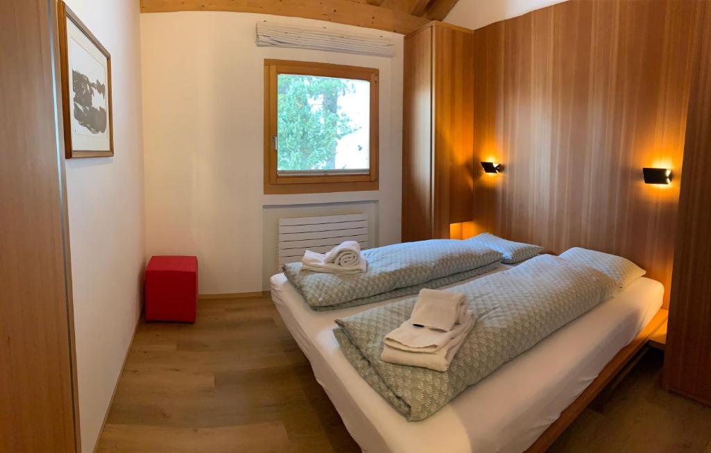 a bedroom with two beds with towels on them at Chesa Chavriol in Pontresina