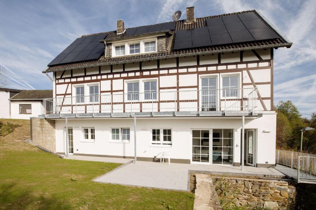 a large white house with a black roof at Bienenhaus 1 in Monschau