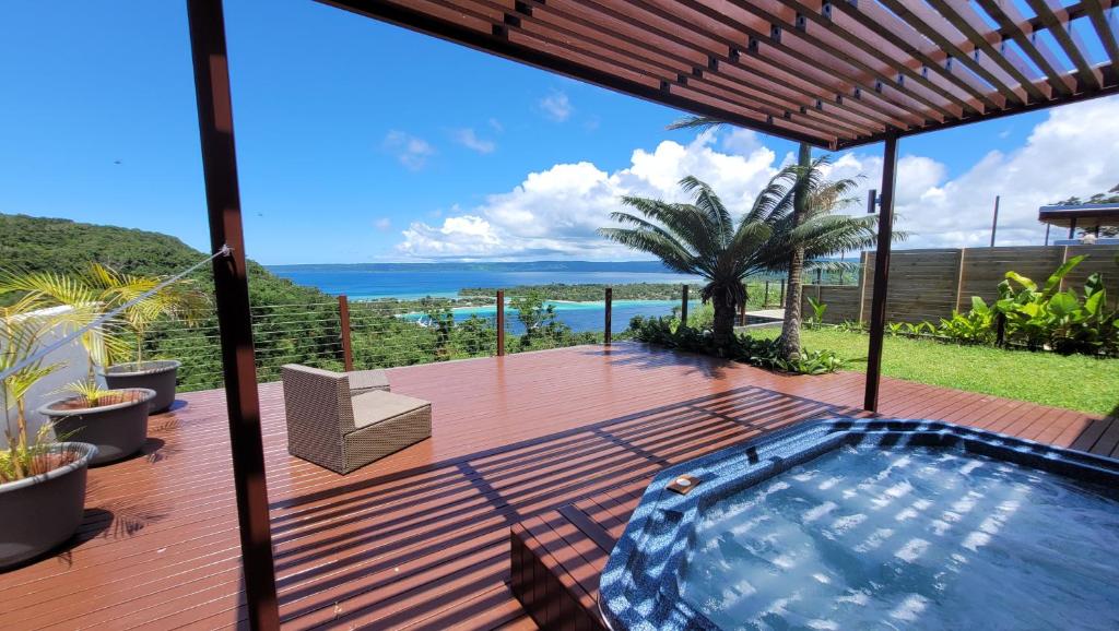 a pool on a deck with a view of the ocean at Longview - stunning views, sleeps 7 in Port Vila