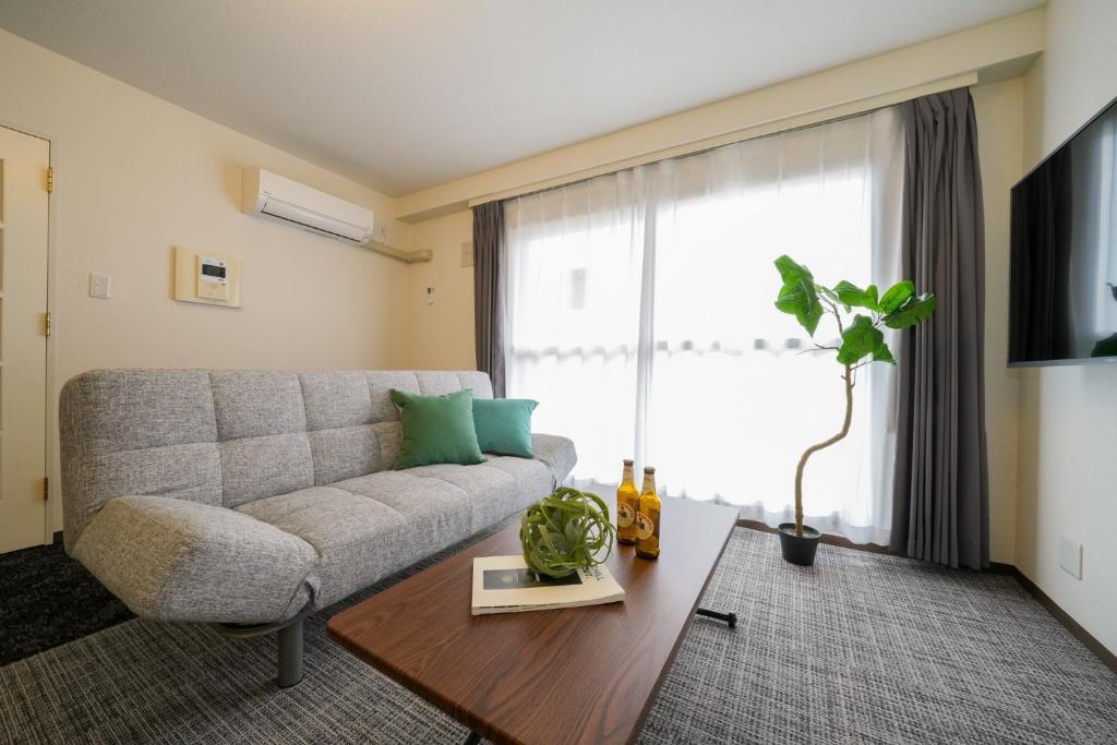 a living room with a couch and a table at 37th Matsui Building 1002 - Vacation STAY 14736 in Sapporo