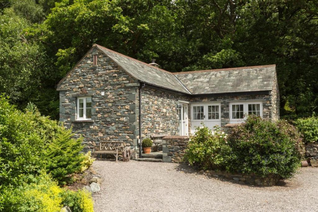 a stone house with a bench in front of it at 1 Bed in Borrowdale SZ163 in Keswick