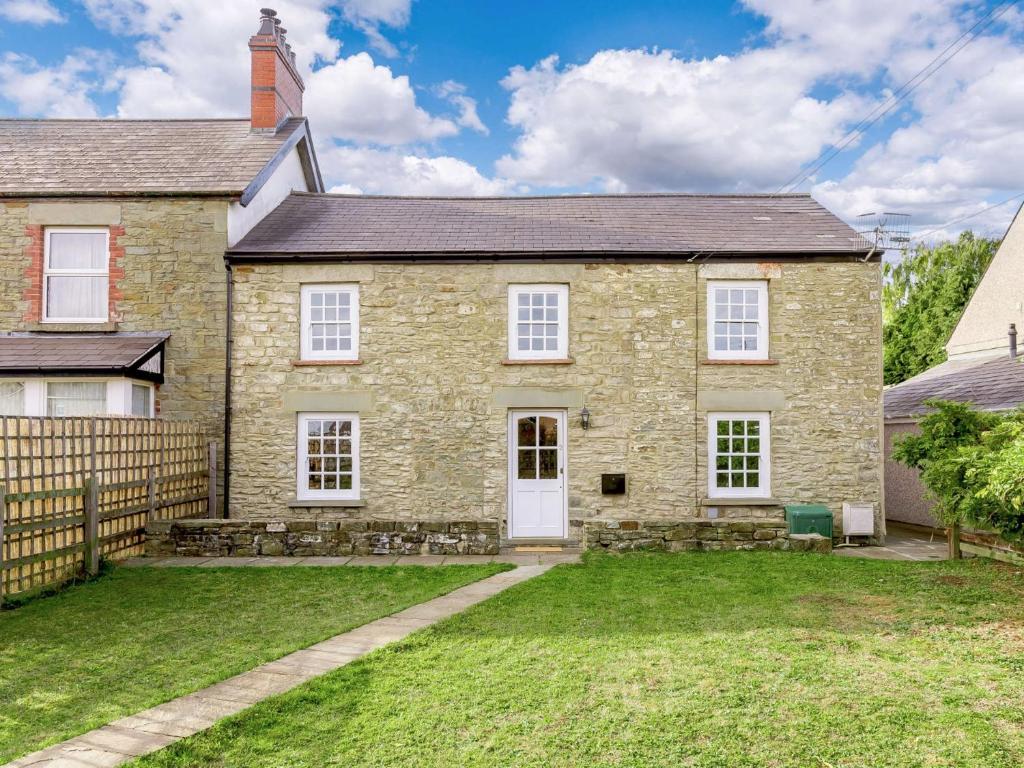 a large stone house with a yard at 3 Bed in Coleford 89806 in Coleford