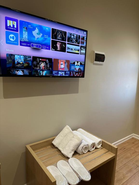 a flat screen tv hanging on a wall with towels at Arial Lofts in Vlorë