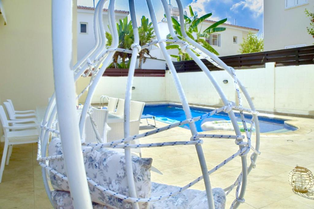 a white water slide next to a swimming pool at Mediterranean Breeze Villa in Protaras