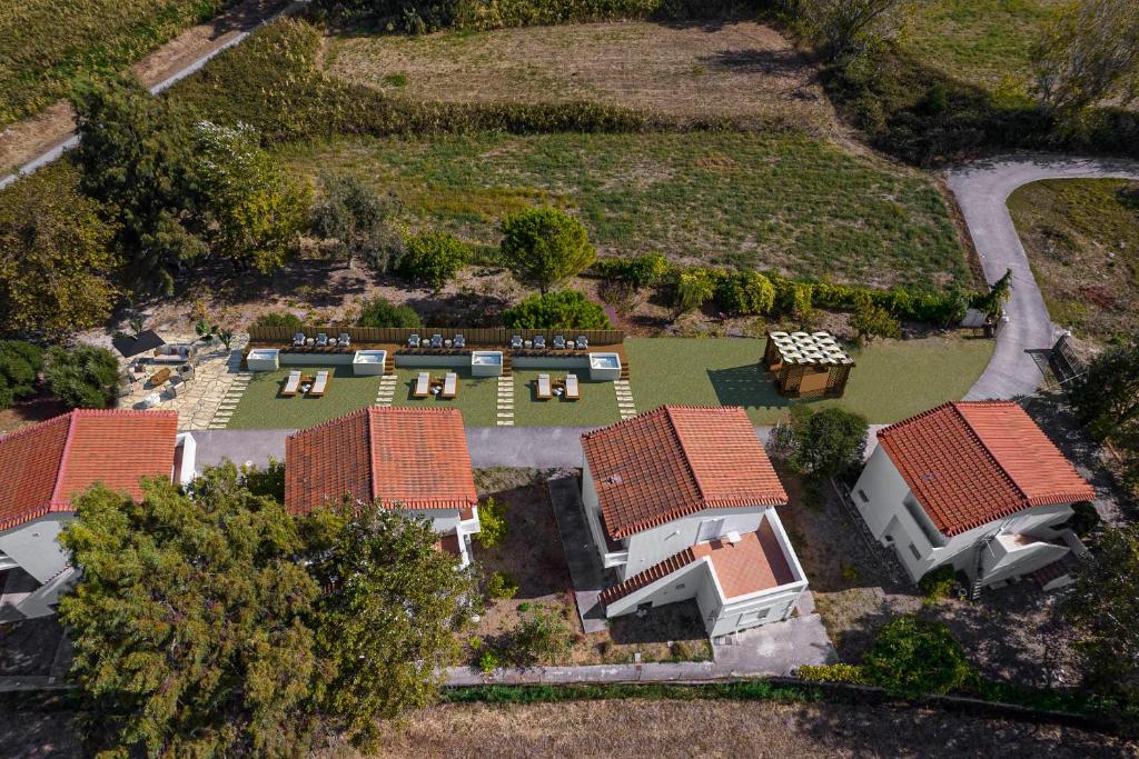 an aerial view of a house with a yard at Naftilos Rosmarinus Apartments in Potokáki