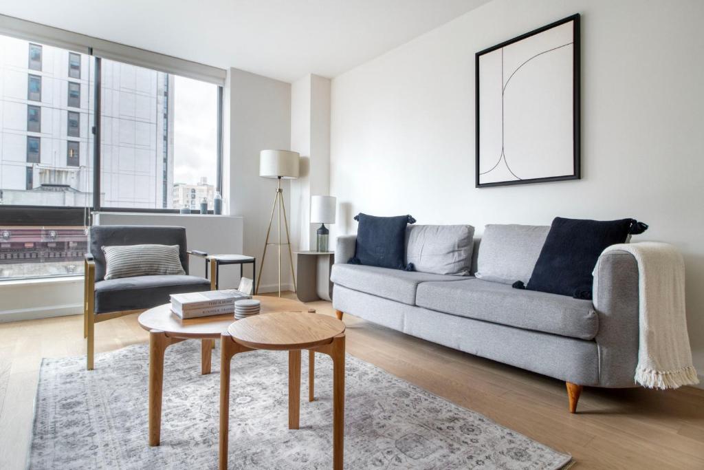 a living room with a couch and a table at Upper West Side 1br w doorman nr park NYC-1219 in New York