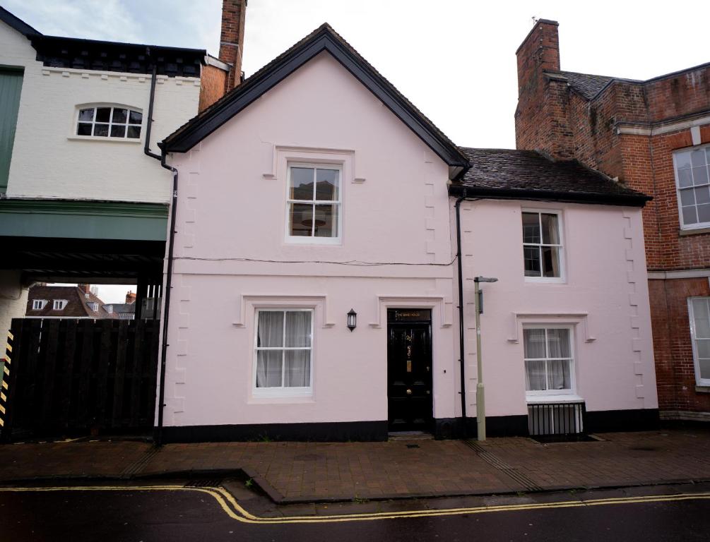 a white house with a black roof at The Bakehouse - central townhouse sleeps 8 people in Winchester