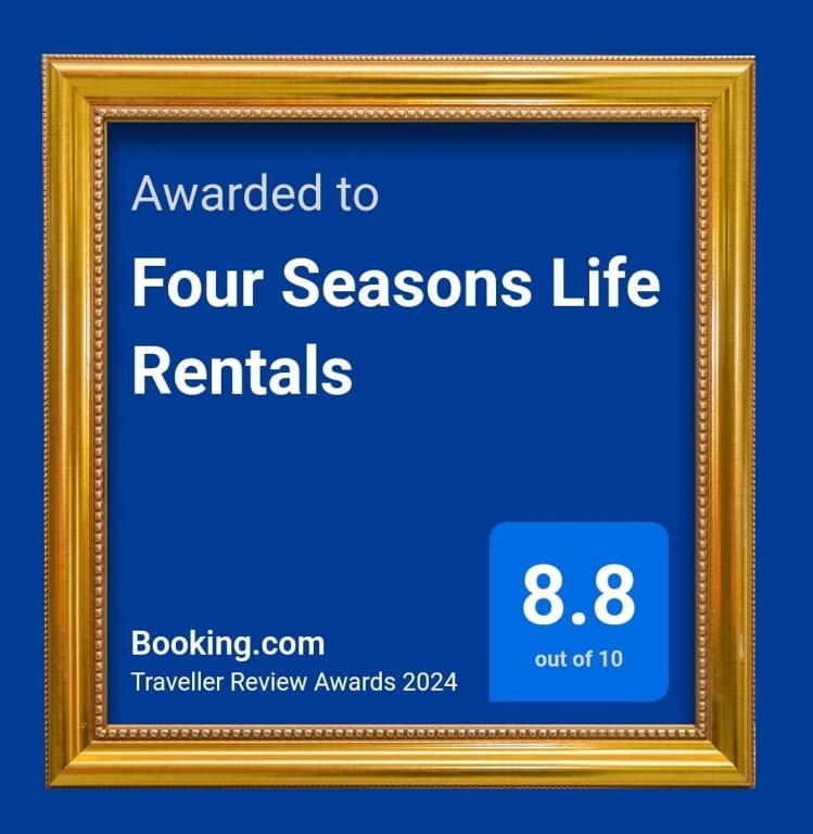 a gold picture frame with the words awarded to four seasons life rentals at Four Seasons Life Rentals in Trikomo