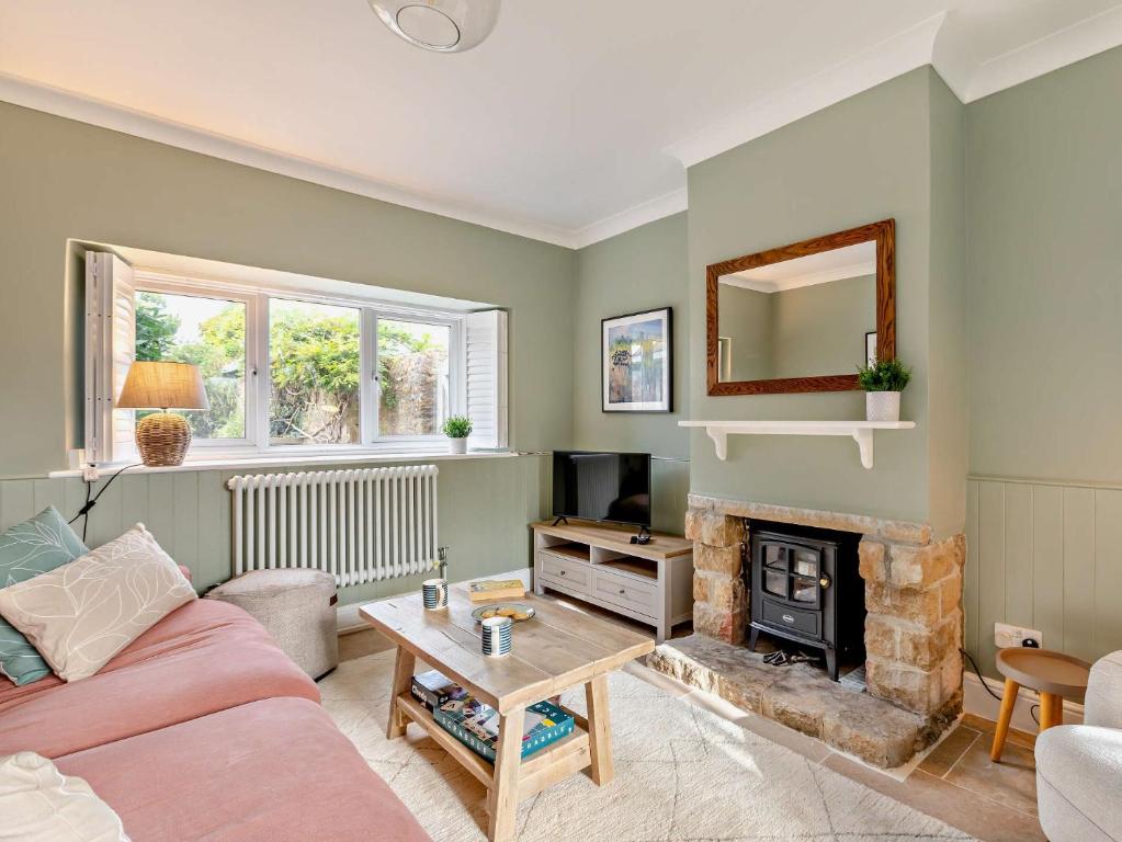 a living room with a couch and a fireplace at 2 Bed in Burton Bradstock 93076 in Burton Bradstock