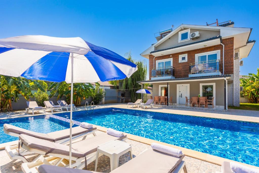 a villa with a swimming pool and a house at Villa Mazoya in Dalyan