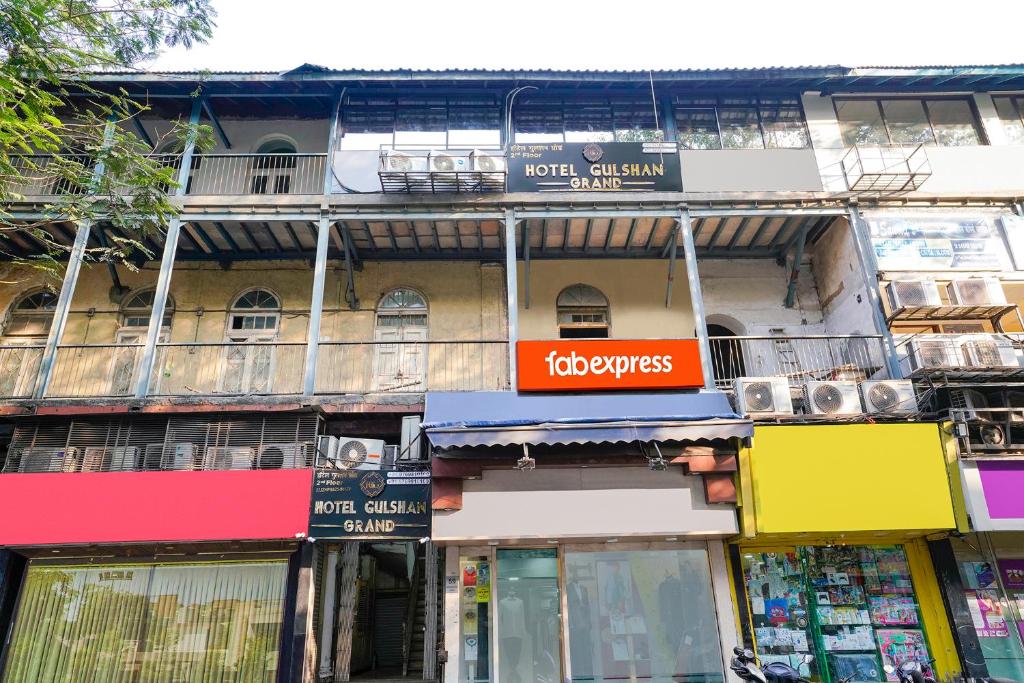 a building with signs on the side of it at FabExpress Gulshan Grand in Mumbai