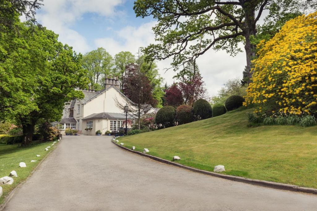 a driveway in front of a white house at Briery Wood Hotel in Ambleside