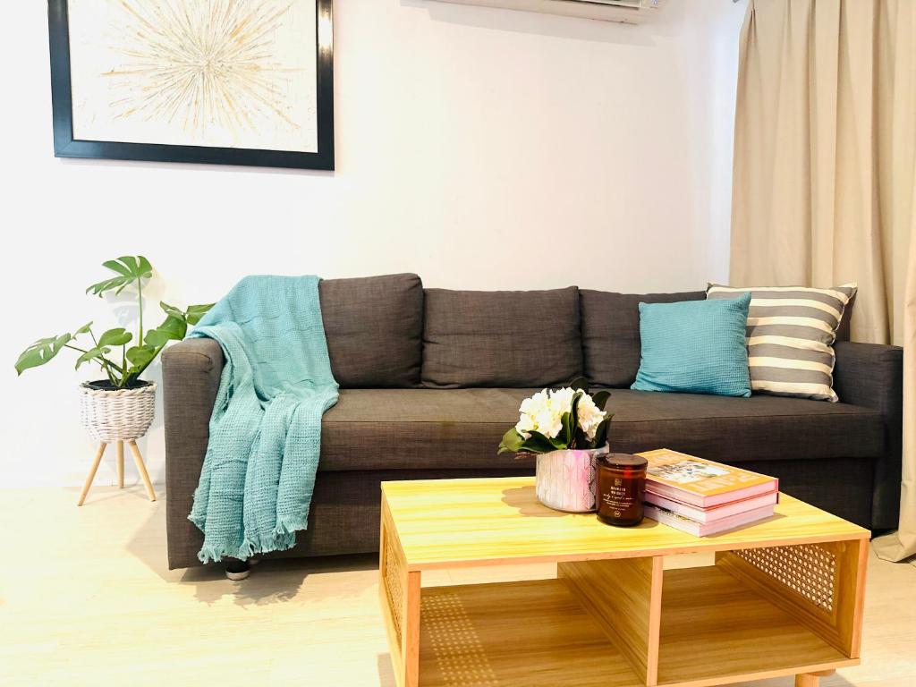 a living room with a couch and a coffee table at Happy Guest house in Newcastle in Minmi