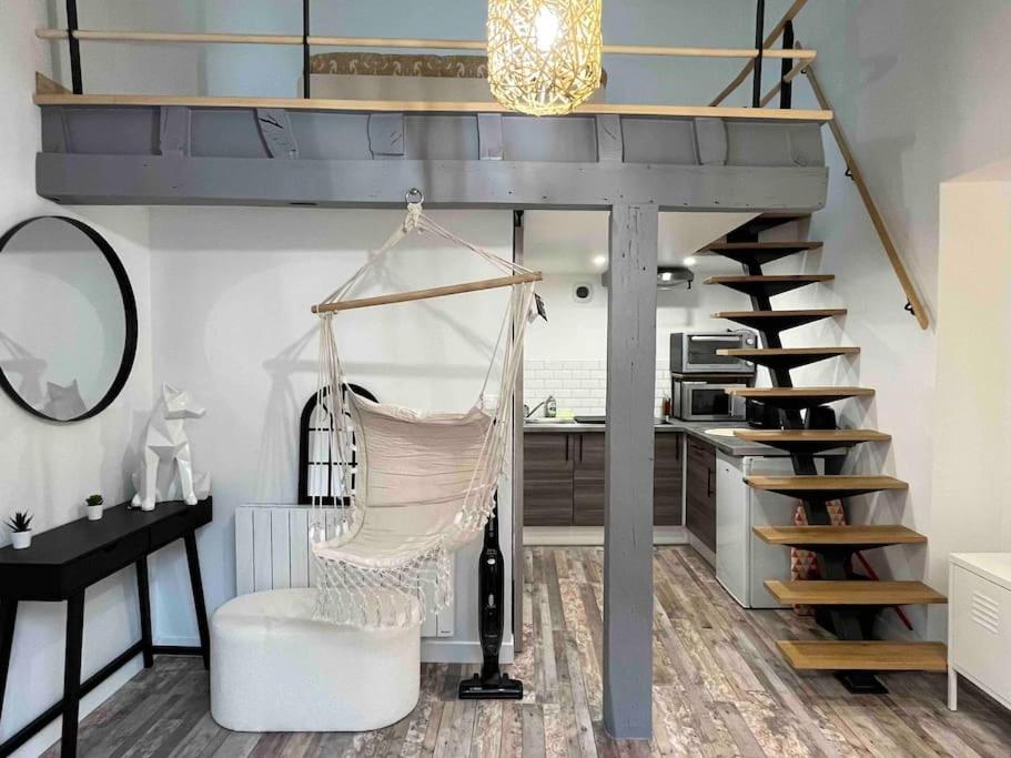 a loft bed with a hammock in a room at Duplex Place du Martroi in Orléans