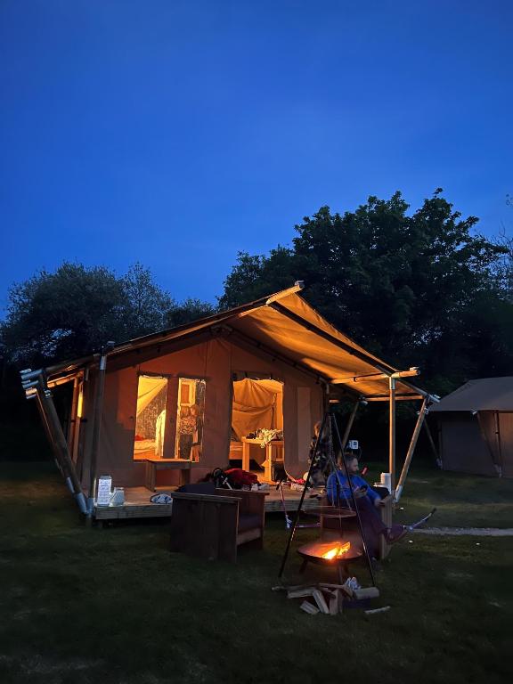 a tent is set up in a field at night at Safari Tent in Pentewan