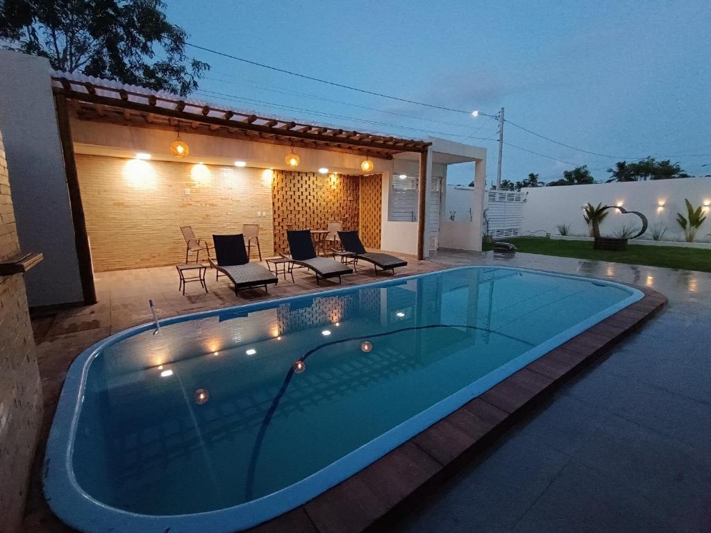 a swimming pool in the backyard of a house at Flats Marina Maragogi in Maragogi