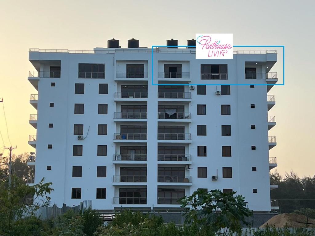 a building with a hotel sign on top of it at Penthouse Living in Mombasa