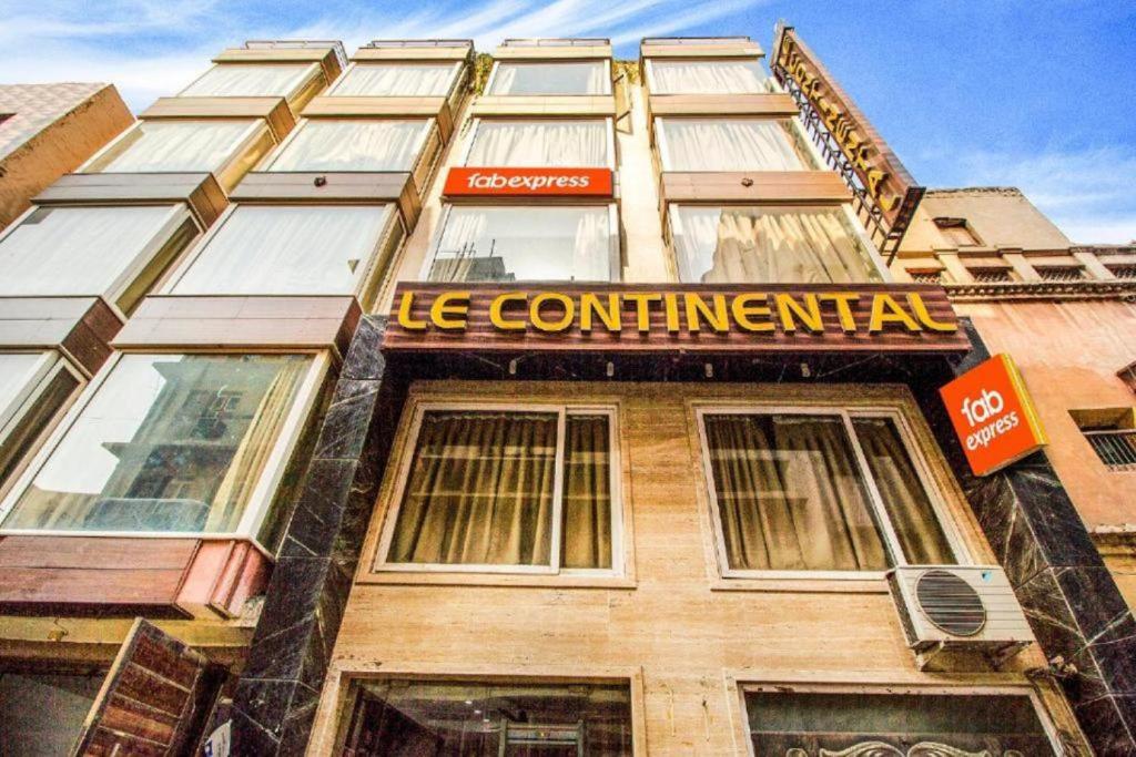 a building with a sign on the front of it at Hotel Le Continental in New Delhi