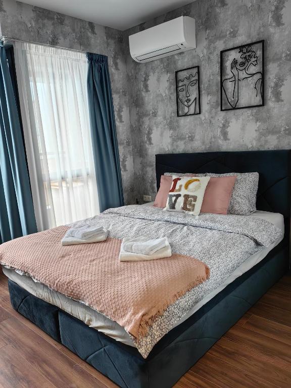 a bedroom with a bed with two towels on it at Luxury Apartment/Studio in Plovdiv