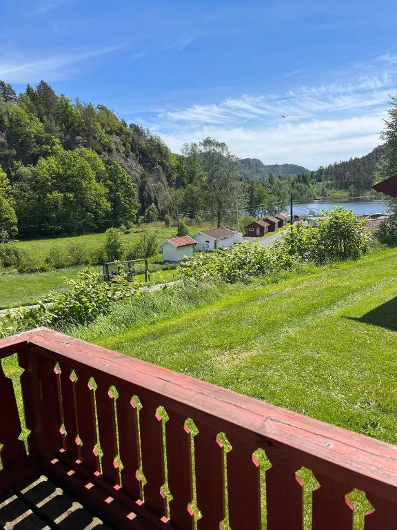 a wooden balcony with a view of a park at Svindland camping in Kvinesdal