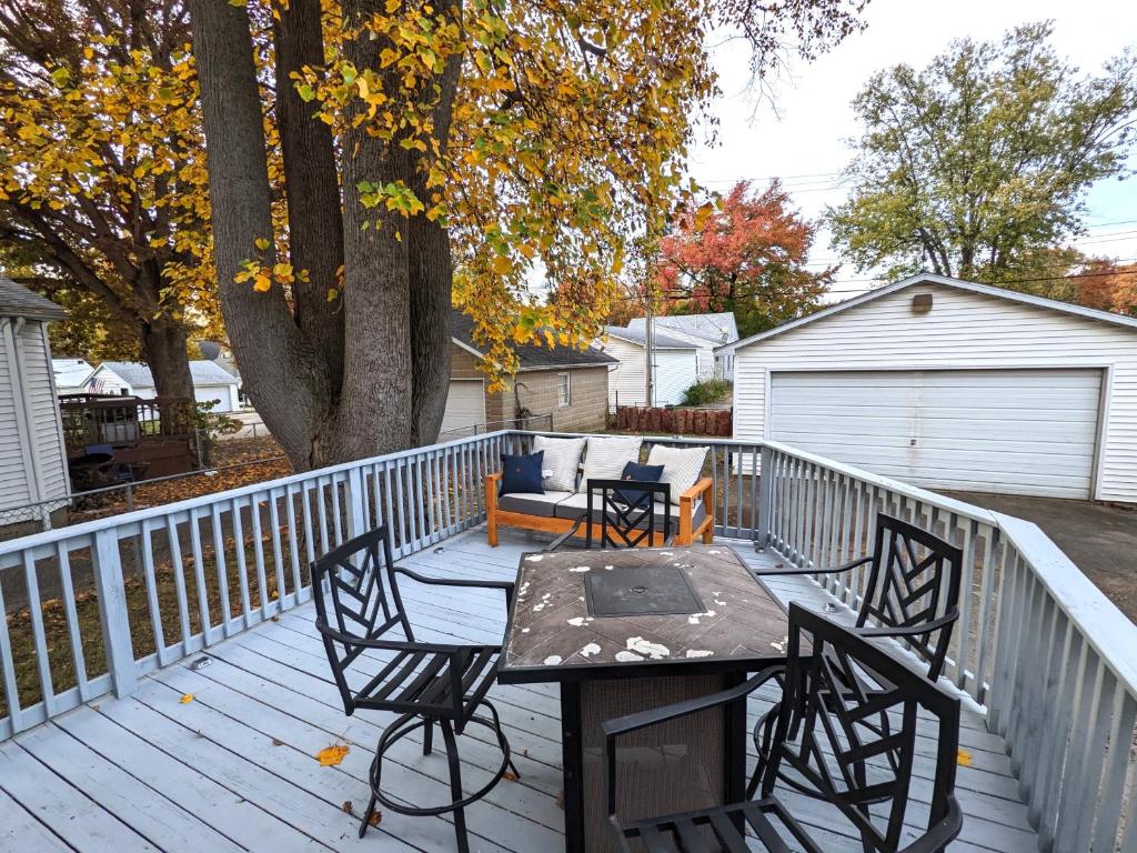 a wooden deck with a table and chairs on it at Fenced backyard, deck, pet-friendly home in Springfield