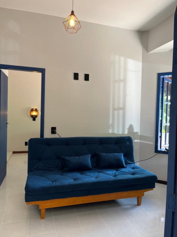 a blue couch sitting in a living room at Pousada Maikai Garden in Porto Belo