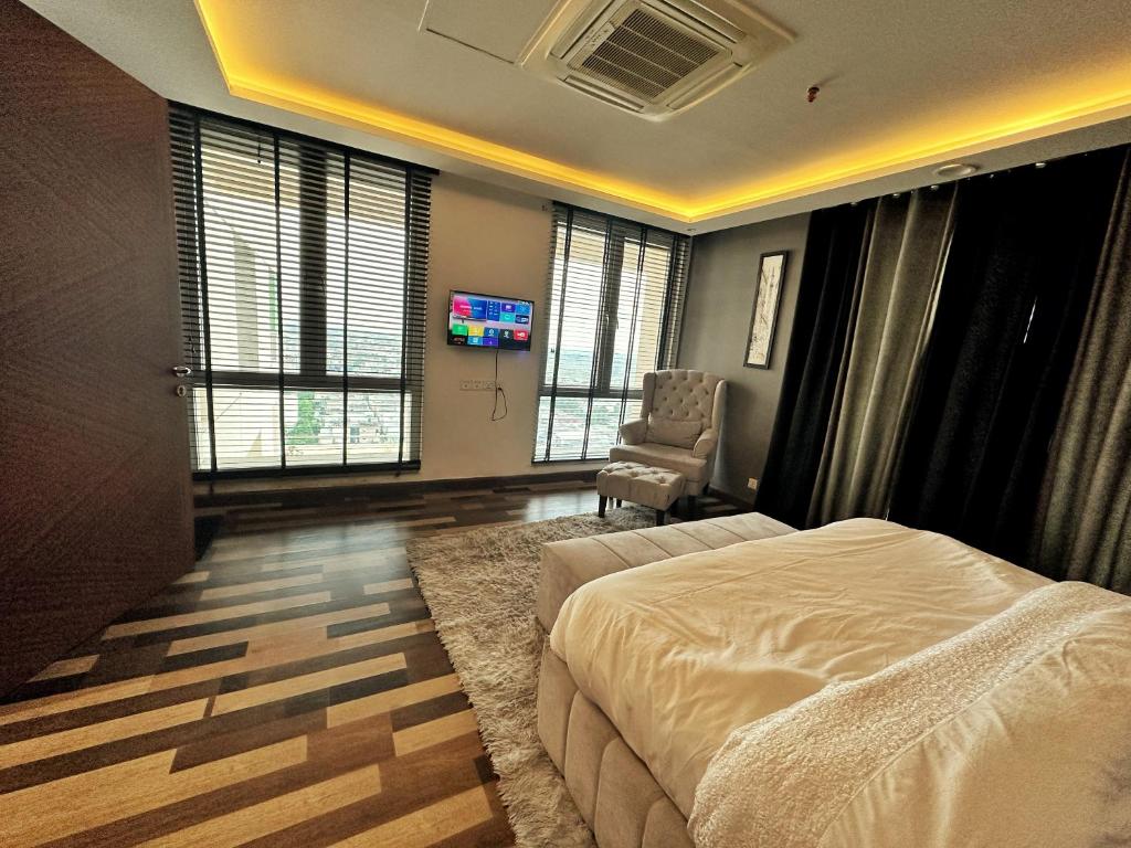 a bedroom with a bed and a tv in it at Executive Presidential suite in Lahore
