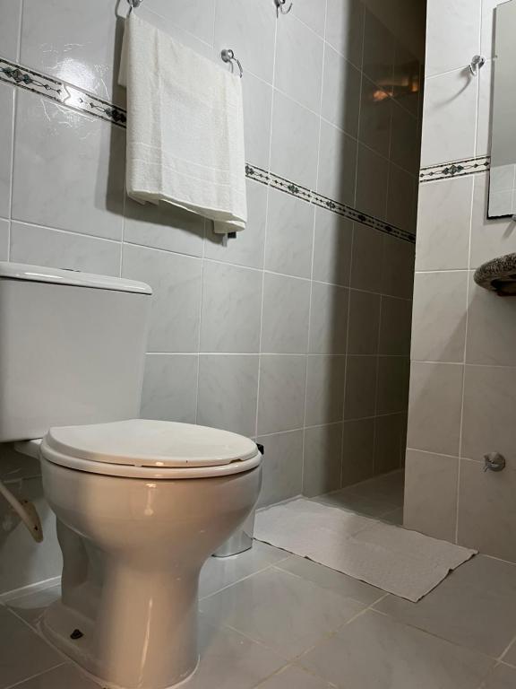 a bathroom with a toilet and a shower at Pousada Maikai Garden in Porto Belo