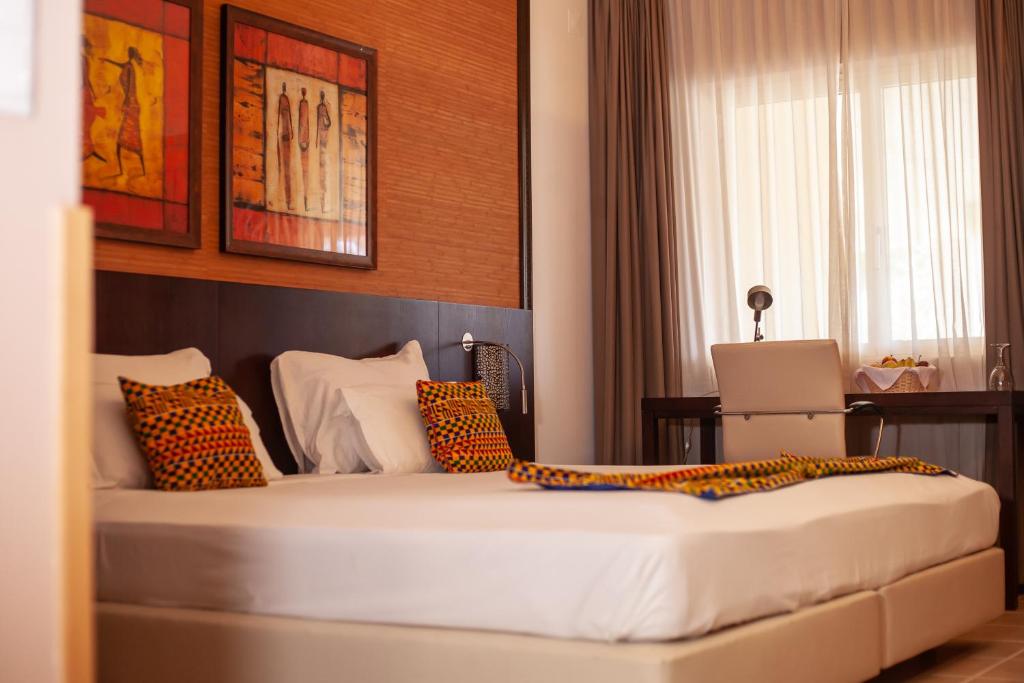 Postel nebo postele na pokoji v ubytování Pestana Tropico Ocean & City Hotel